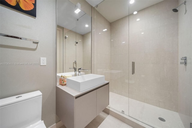 1000 Brickell Plz Unit Ph5603, Miami, FL 33131 - bathroom featuring a stall shower, toilet, vanity, and tile patterned flooring