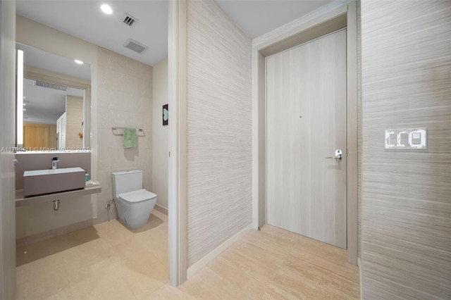 1000 Brickell Plz Unit Ph5603, Miami, FL 33131 - bathroom featuring toilet, vanity, and tile walls
