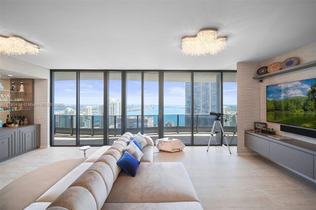 1000 Brickell Plz Unit Ph5603, Miami, FL 33131 - living room featuring floor to ceiling windows, a chandelier, light wood finished floors, and plenty of natural light