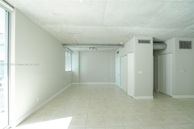 690 SW 1st Ct Unit 2032, Miami, FL 33130 - spare room with light tile patterned flooring and baseboards
