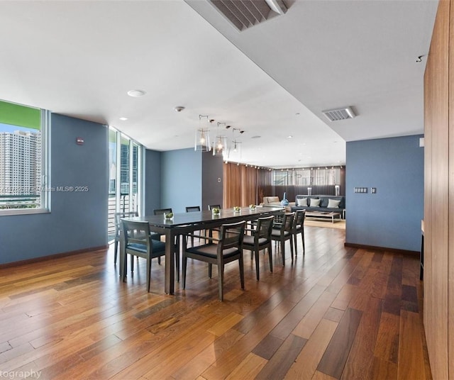 335 S Biscayne Blvd Unit 2003, Miami, FL 33131 - dining area with visible vents, hardwood / wood-style floors, and baseboards