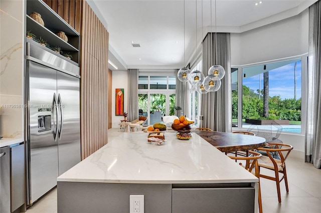2670 Cypress Ln, Weston, FL 33332 - kitchen with a center island, light stone counters, modern cabinets, open shelves, and built in refrigerator