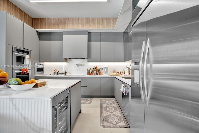 2670 Cypress Ln, Weston, FL 33332 - kitchen featuring light countertops, gray cabinets, stainless steel appliances, and modern cabinets