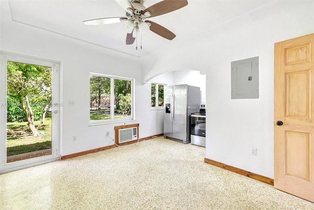 8440 NE 1st Ave, Miami, FL 33138 - empty room featuring arched walkways, light speckled floor, electric panel, and baseboards