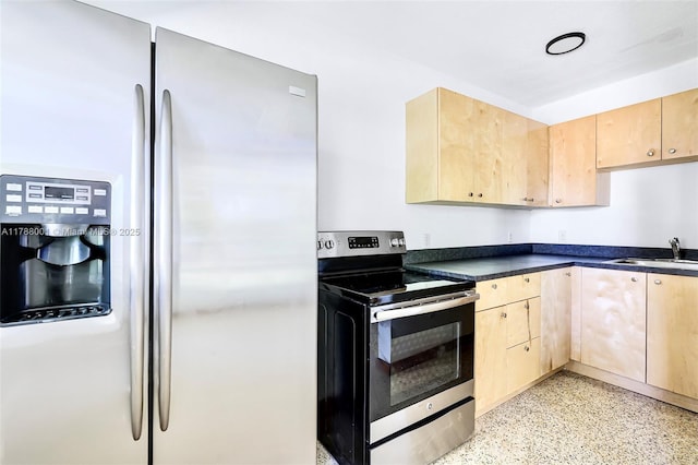 8440 NE 1st Ave, Miami, FL 33138 - kitchen with light speckled floor, light brown cabinetry, stainless steel appliances, dark countertops, and a sink