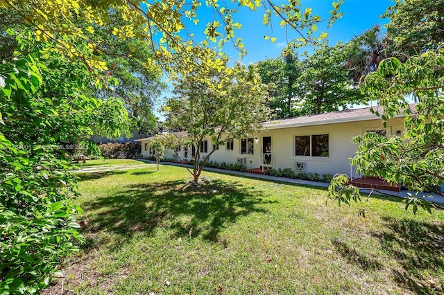 8440 NE 1st Ave, Miami, FL 33138 - exterior space with stucco siding and a lawn