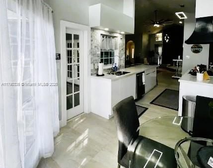 15618 SE US Highway 301, Hawthorne, FL 32640 - kitchen with white cabinetry, arched walkways, ceiling fan, light countertops, and dishwasher