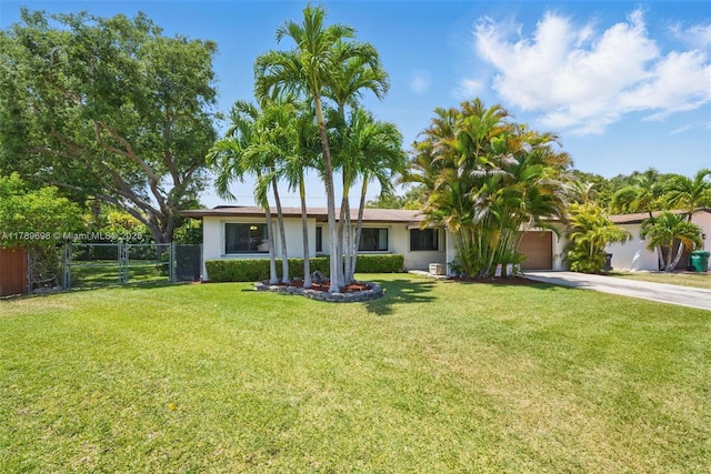ranch-style house featuring fence, stucco siding, an attached garage, driveway, and a front yard