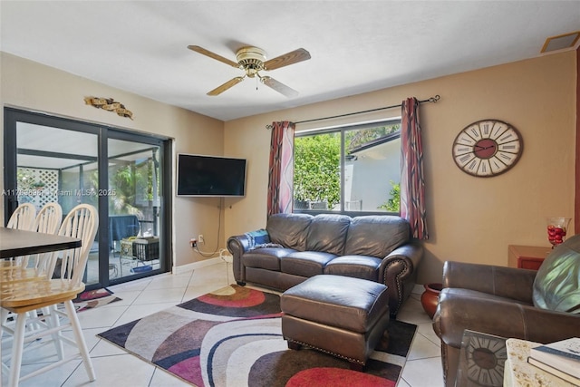 living room featuring a ceiling fan, baseboards, light tile patterned flooring, and visible vents