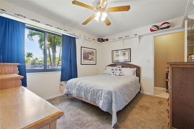 carpeted bedroom with baseboards and a ceiling fan