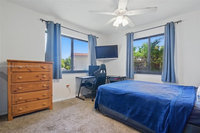 bedroom featuring carpet floors, a ceiling fan, and multiple windows