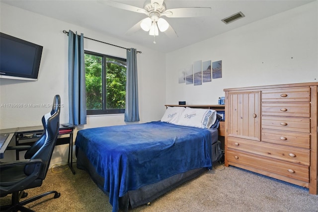 carpeted bedroom featuring visible vents and a ceiling fan