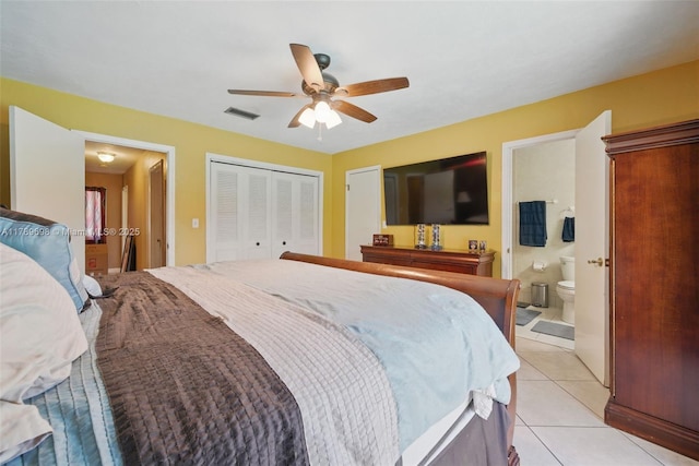 bedroom with visible vents, a ceiling fan, light tile patterned floors, ensuite bath, and a closet