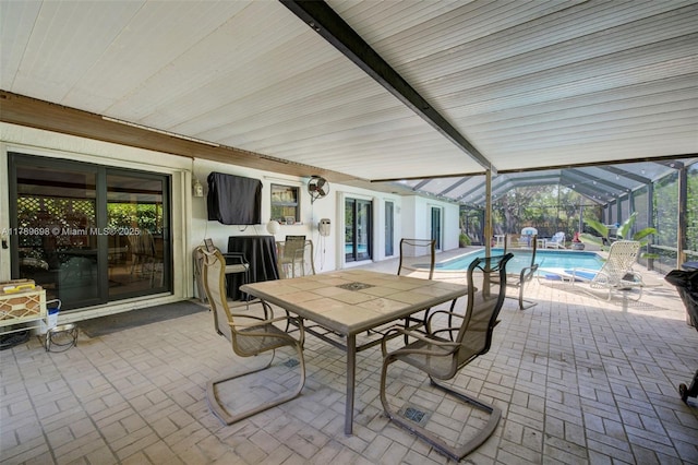view of patio featuring glass enclosure and an outdoor pool