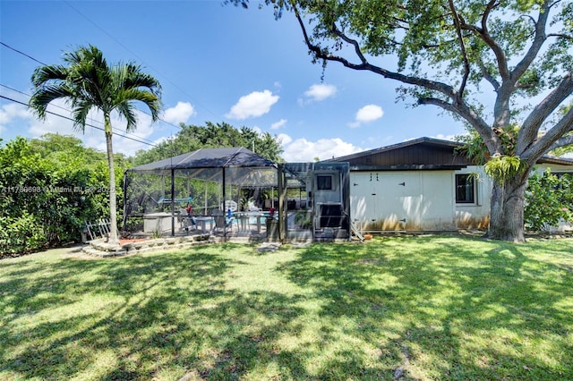 view of yard with an outdoor pool, a lanai, and a patio