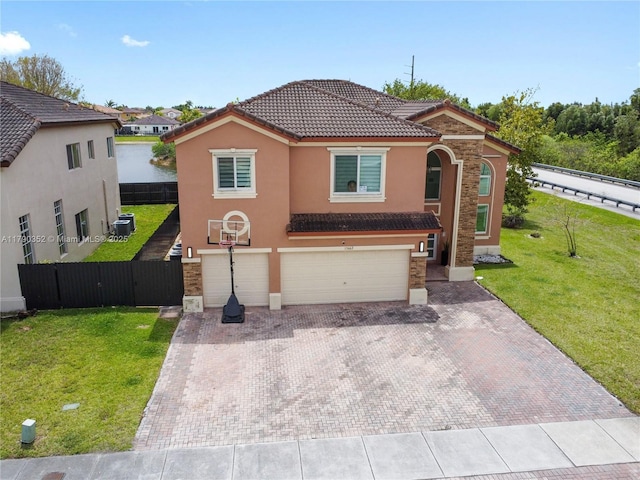 view of front of house with a tiled roof, stucco siding, an attached garage, decorative driveway, and stone siding