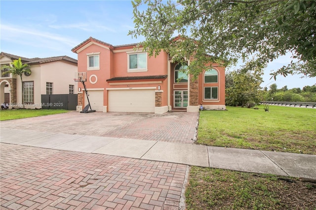 view of front facade with stucco siding, a front lawn, decorative driveway, and a garage