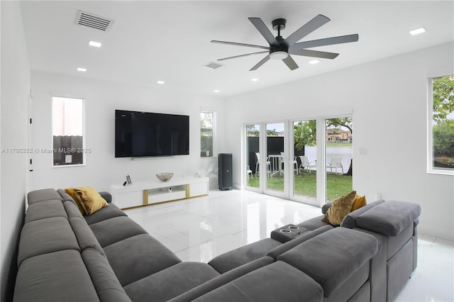 living area with ceiling fan, baseboards, visible vents, and recessed lighting