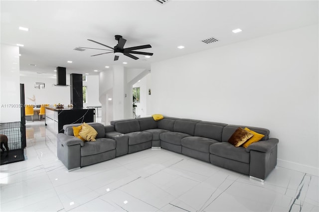 living area featuring baseboards, a ceiling fan, visible vents, and recessed lighting
