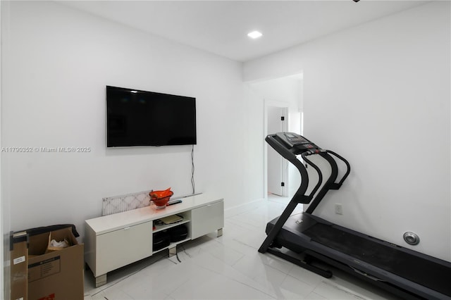workout area featuring marble finish floor