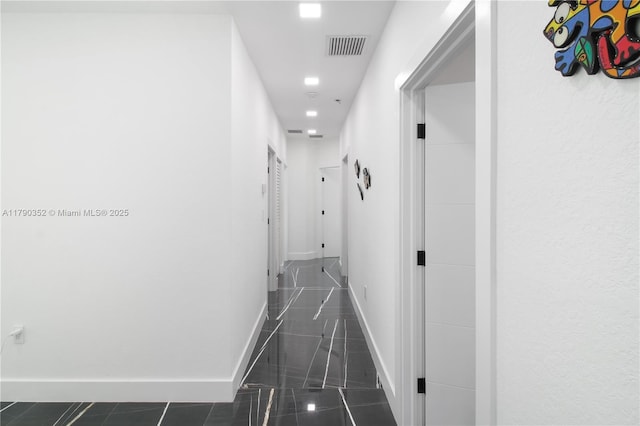 corridor featuring visible vents and baseboards