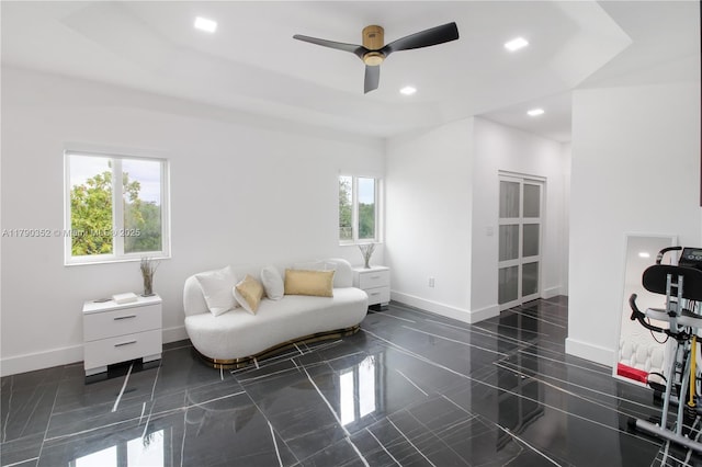 interior space with ceiling fan, baseboards, granite finish floor, and recessed lighting