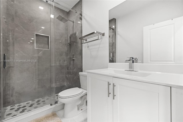 full bathroom featuring vanity, toilet, and a stall shower