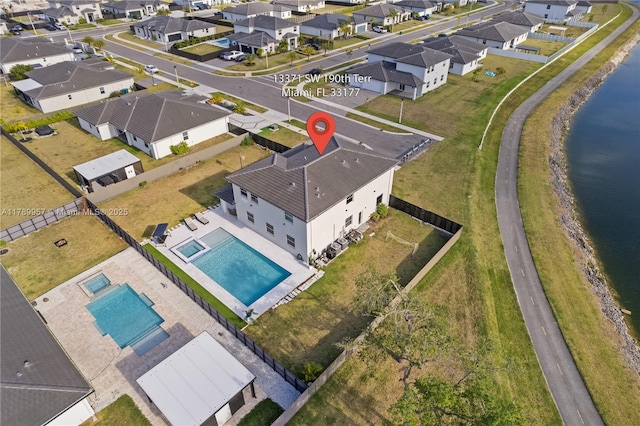 birds eye view of property with a residential view and a water view
