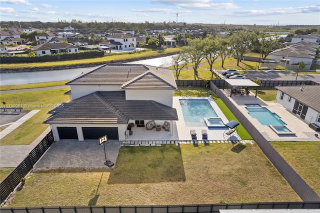 drone / aerial view with a water view and a residential view