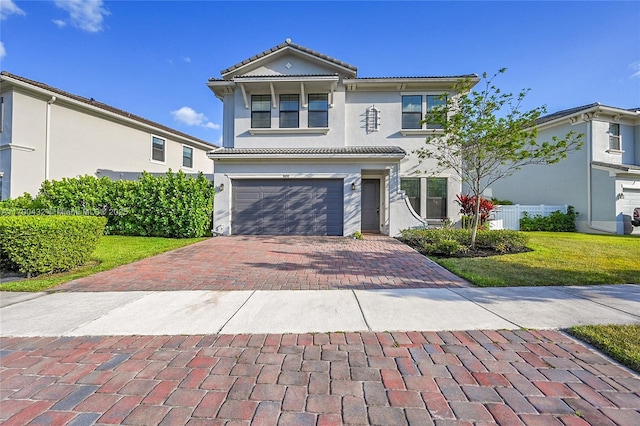 8650 NW 39th Ct, Coral Springs, FL 33065 - traditional-style house featuring a tiled roof, decorative driveway, an attached garage, and stucco siding