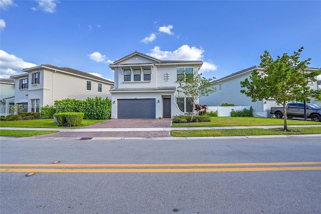 8650 NW 39th Ct, Coral Springs, FL 33065 - traditional-style house featuring a front yard, decorative driveway, fence, an attached garage, and stucco siding