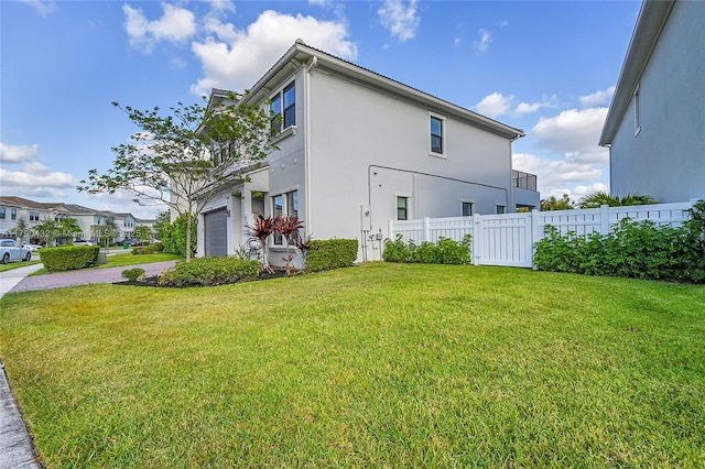 8650 NW 39th Ct, Coral Springs, FL 33065 - view of property exterior with a lawn, fence, driveway, and stucco siding