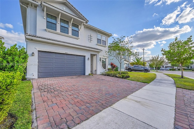 8650 NW 39th Ct, Coral Springs, FL 33065 - view of front facade featuring a garage, stucco siding, and decorative driveway