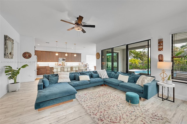 8650 NW 39th Ct, Coral Springs, FL 33065 - living room with a ceiling fan and light wood-style floors