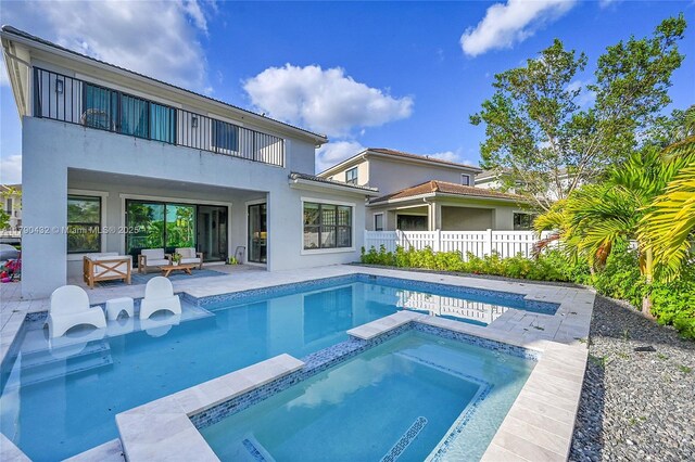 8650 NW 39th Ct, Coral Springs, FL 33065 - back of house featuring fence, a balcony, a patio, stucco siding, and an outdoor living space