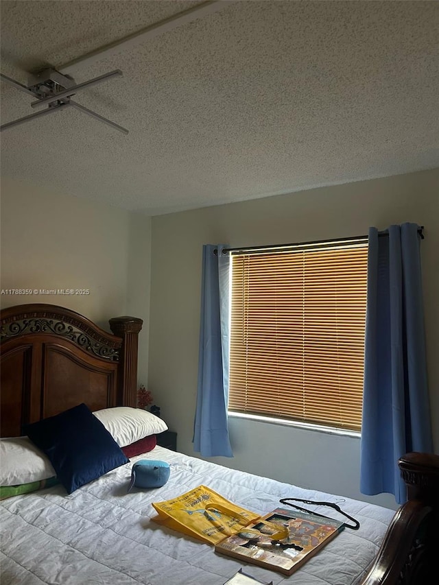 2480 W 67th Pl Unit 12-12, Hialeah, FL 33016 - bedroom with a textured ceiling and ceiling fan