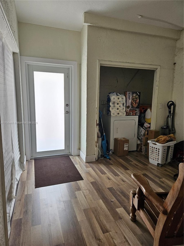 interior space with washer / clothes dryer and wood finished floors