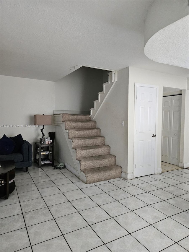 interior space featuring tile patterned flooring and a textured ceiling