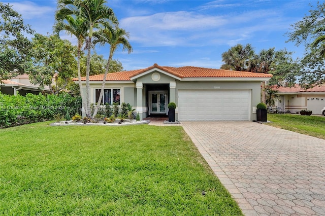 view of front of house featuring a garage, french doors, a front lawn, and decorative driveway