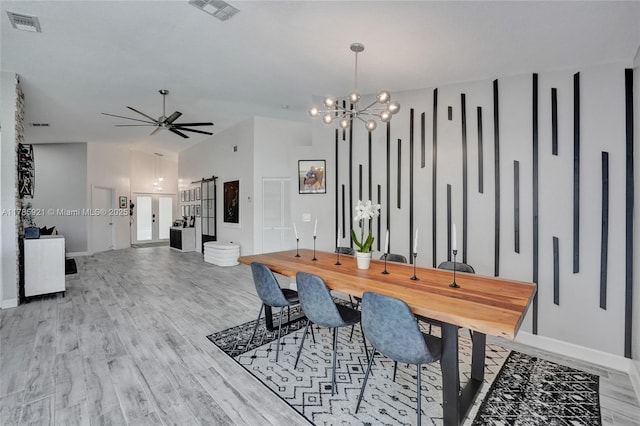 dining area featuring baseboards, wood finished floors, and visible vents