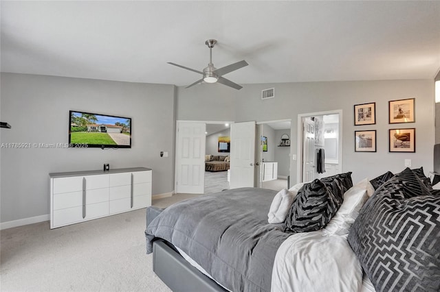 bedroom featuring ensuite bathroom, baseboards, light colored carpet, lofted ceiling, and visible vents