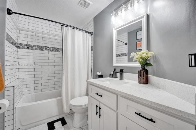 bathroom featuring visible vents, toilet, vanity, and shower / tub combo