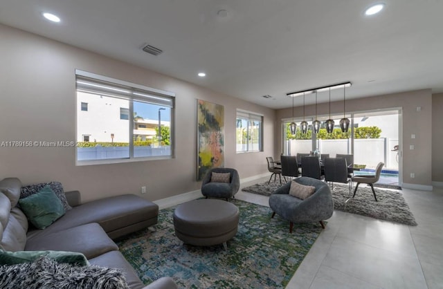 tiled living room featuring visible vents, baseboards, and recessed lighting