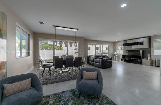 living room featuring plenty of natural light, visible vents, and recessed lighting
