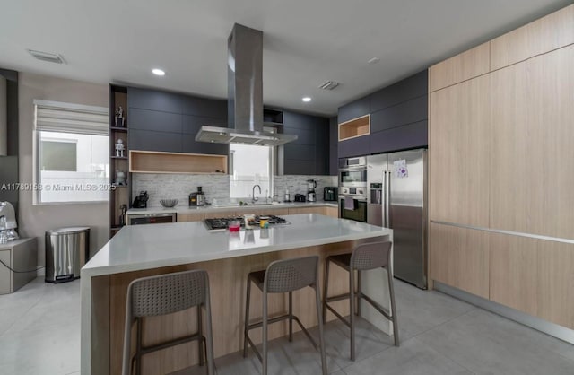 kitchen featuring open shelves, a kitchen breakfast bar, stainless steel appliances, and modern cabinets
