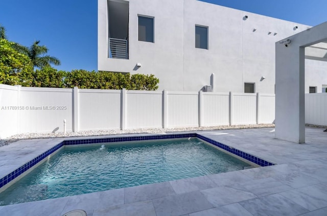 view of swimming pool with a patio area, a fenced in pool, and a fenced backyard