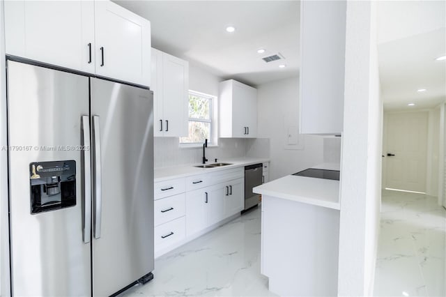 1625 NW 9th Ct, Homestead, FL 33030 - kitchen featuring appliances with stainless steel finishes, a sink, tasteful backsplash, light marble finish floors, and recessed lighting