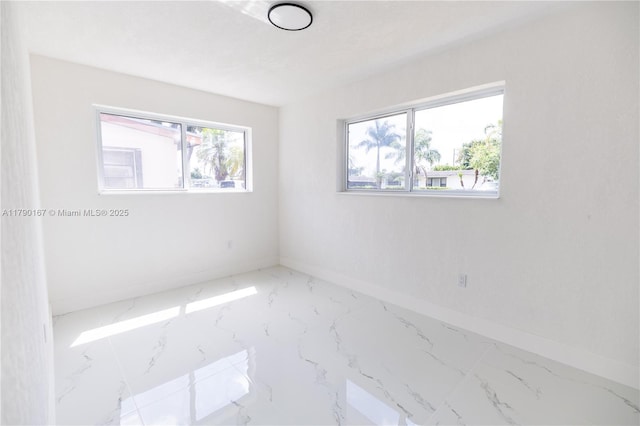 1625 NW 9th Ct, Homestead, FL 33030 - empty room with marble finish floors and baseboards