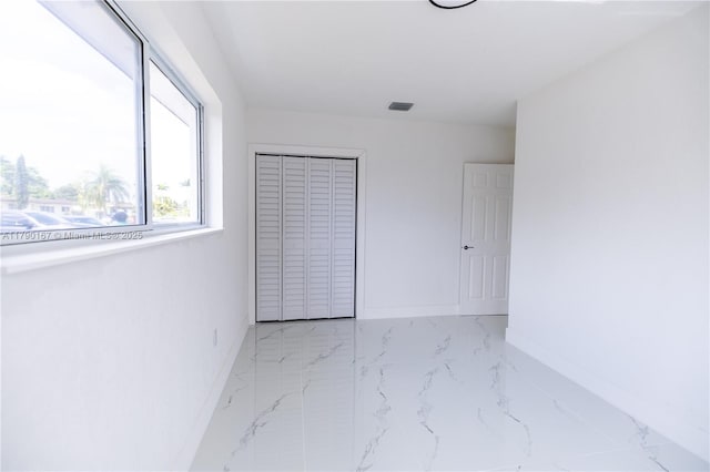 1625 NW 9th Ct, Homestead, FL 33030 - unfurnished bedroom with marble look tile flooring and baseboards
