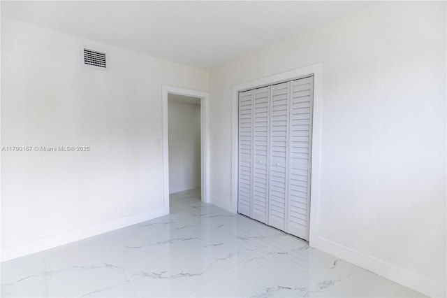 1625 NW 9th Ct, Homestead, FL 33030 - unfurnished bedroom with marble tiled flooring, baseboards, and a closet